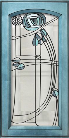 an art nouveau style glass window with blue frame