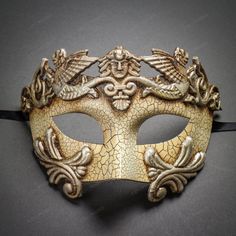 This Greek-Roman Emperor Mask Is Made From Paper Molding And Has An Aged Finish. Decorated With Cracked Texture On The Mask. The Mask Is About 6" Tall And 7" Wide. The Masquerade Mask Will Make A Great Costume Accessory. Made From Plastic With Paper Molding And Hand-Painted. Great For A Masquerade Ball Or Venetian Costume Features Mythological Beasts The Mask Is Approximately 6" Tall And 7" Wide Hand-Painted With An Aged And Cracked Finish Color: Crack White Silver Usm-M2599-Wtsv Vintage Eye Mask For Masquerade, Vintage Eye Mask For Costume Party, Vintage Eye Mask For Masquerade Costume Party, Vintage Masquerade Mask For Mardi Gras, Masquerade Event, Gold Masquerade Mask, Masquerade Prom, Masquerade Ball Party, Mens Masquerade Mask