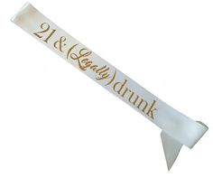 a white ribbon with gold lettering on it