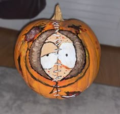 a pumpkin with a face painted on it