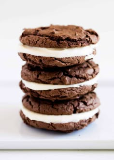 a stack of chocolate cookies with white frosting