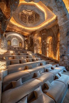 an empty theater with seating and stone walls