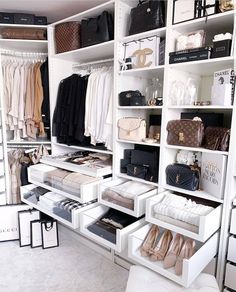 an organized closet with white shelving and lots of shoes, handbags and purses