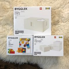 two boxed legos sitting on top of a white rug