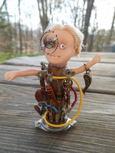 a doll with glasses on top of a bicycle