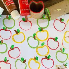 an apple themed paper plate is on the table next to some crafting supplies and glue