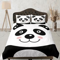 a panda bear bed with black and white sheets