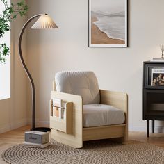 a living room with a lamp, chair and pictures on the wall in it's corner