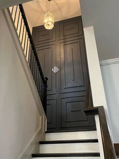 the stairs are painted black and white with an arrow symbol on one side, and another door in the other