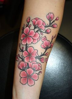 a woman's arm with pink flowers on it