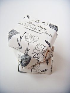 an origami box with flowers and money printed on it