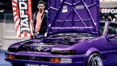 a purple car with its hood open and the hood up