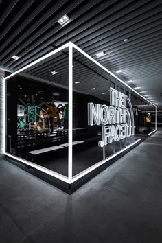 the north face storefront is lit up with neon lights and an advertisement for its brand