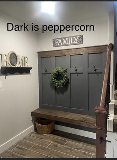 a entryway with a bench and wreath on the wall