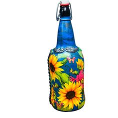 a blue glass bottle with sunflowers painted on it