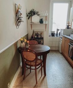 a table and chairs in a small kitchen