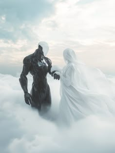 a man and woman standing in the clouds holding hands