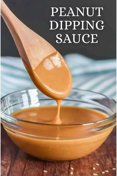 the best peanut sauce recipe is in a glass bowl with a wooden spoon full of peanut butter