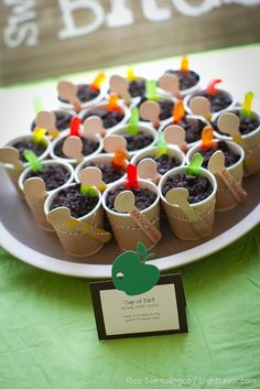 cupcakes in paper cups on a plate with name tags and place card holders