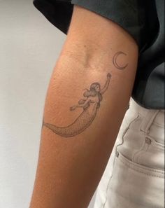 a person with a tattoo on their arm holding onto the arm of another person's arm