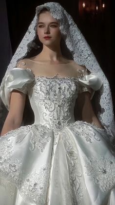 a woman in a white wedding dress and veil