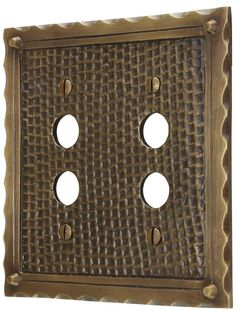 an old fashioned metal wall plate with four holes