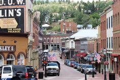 an old town with cars parked on the street