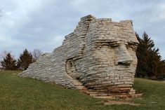 a stone sculpture of a man's head made out of bricks