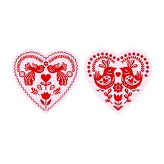 two heart shaped paper cut outs with birds and flowers on them, one red and the other white