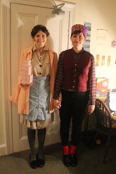 two women standing next to each other in front of a door wearing clothes and shoes