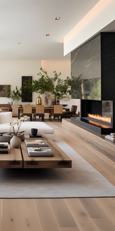 a modern living room with wood flooring and white couches in front of a fireplace