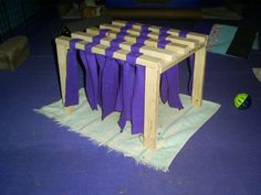 a wooden table with purple cloths on it