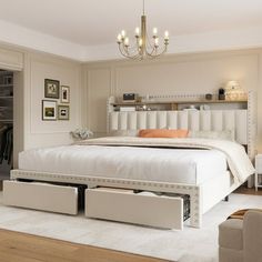 a white bed sitting in a bedroom on top of a hard wood floor