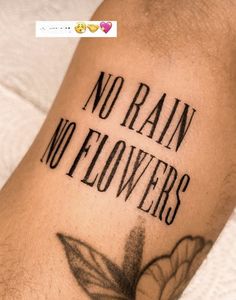 a person with a tattoo on their arm that says no rain, no flowers