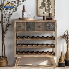 an old wooden wine rack with bottles and glasses on it in front of a white wall