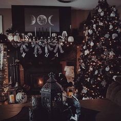 a living room decorated for halloween with a large tree and decorations on the fireplace mantel