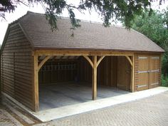 a wooden garage with two cars parked in it