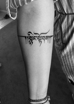 a person with a tattoo on their leg that reads,'strength'in black ink