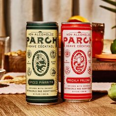 two cans of parch are sitting on a table next to some fruit and drinks