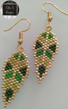 the earrings are made out of gold and green beads