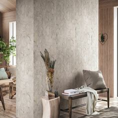 a living room filled with furniture next to a wooden floor and wall covered in stone