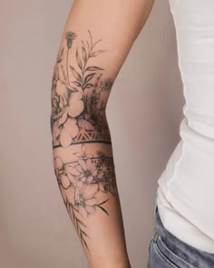 a woman's arm with flowers on it