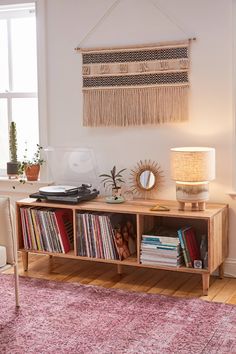 a room with a record player, lamp and rug