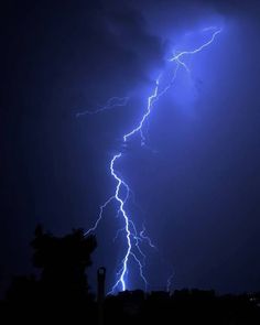 a lightning bolt striking through the night sky