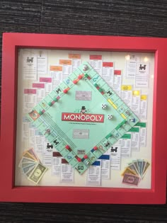 a monopoly board game in a red frame with money on the side and words written below it