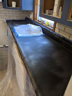 the counter top is covered in plastic and ready to be installed into the kitchen cabinets