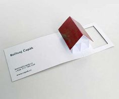 a red and white object is on top of a business card that says boilvol cank