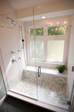 a walk in shower sitting next to a window