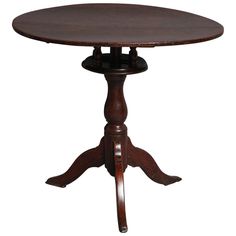 a round wooden table with four legs