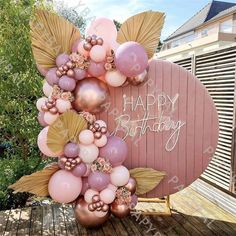 a happy birthday sign with balloons and flowers